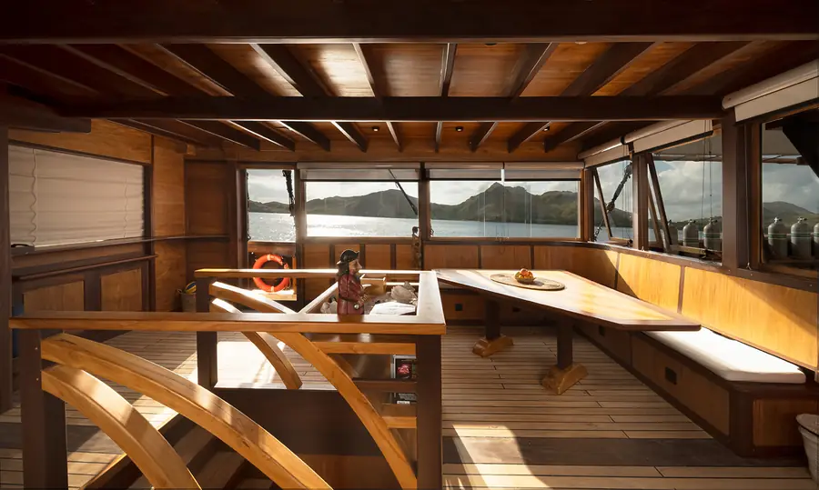 The warm timber saloon of a classic phinisi